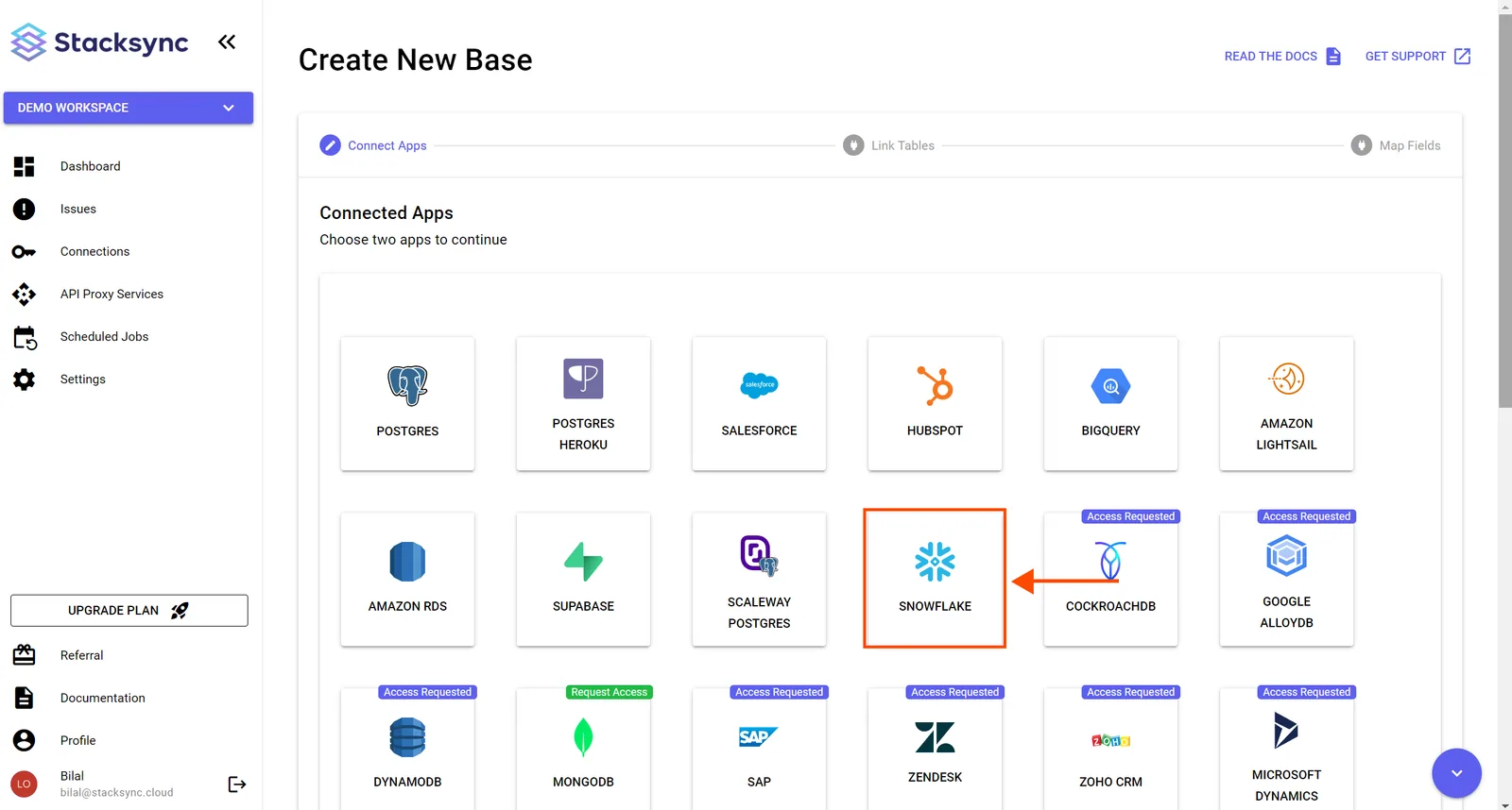Stacksync Create New Base, Connect Apps step, with an arrow pointing to the Snowflake app tile.