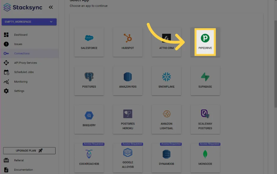 Stacksync "Select App" grid with an arrow pointing to the Pipedrive connector tile.