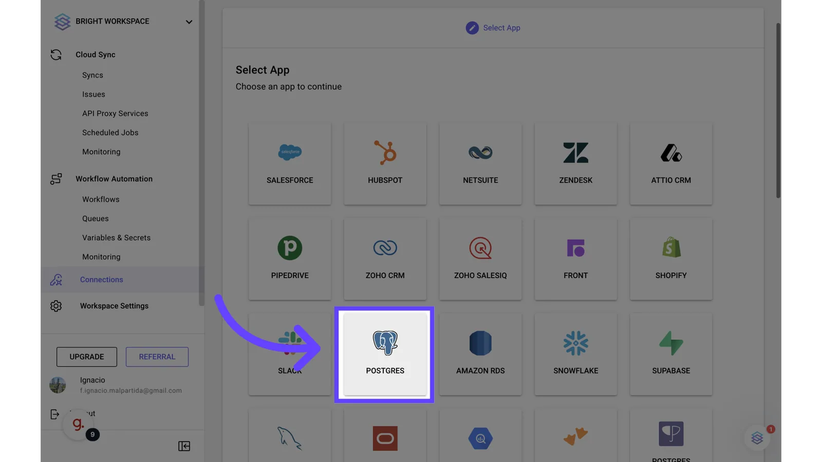 Stacksync "Select App" grid with an arrow pointing to the Postgres connector tile.